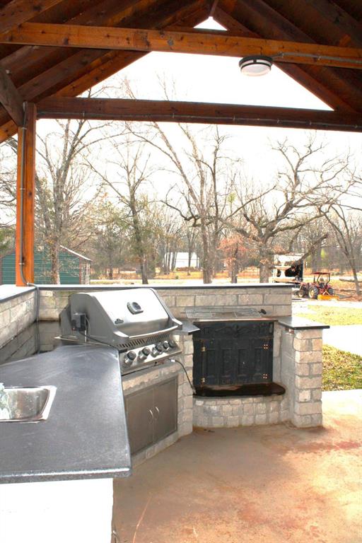 7320 County Road 3512 Quinlan, TX 75474 - Photo 29 of 35 a open kitchen with a stove and a view of the floor
