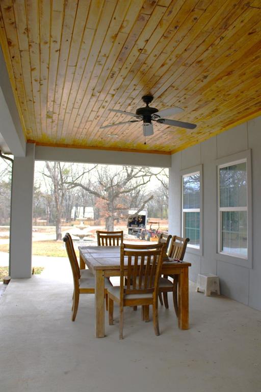 7320 County Road 3512 Quinlan, TX 75474 - Photo 30 of 35 a view of a dining room with furniture large windows and wooden floor