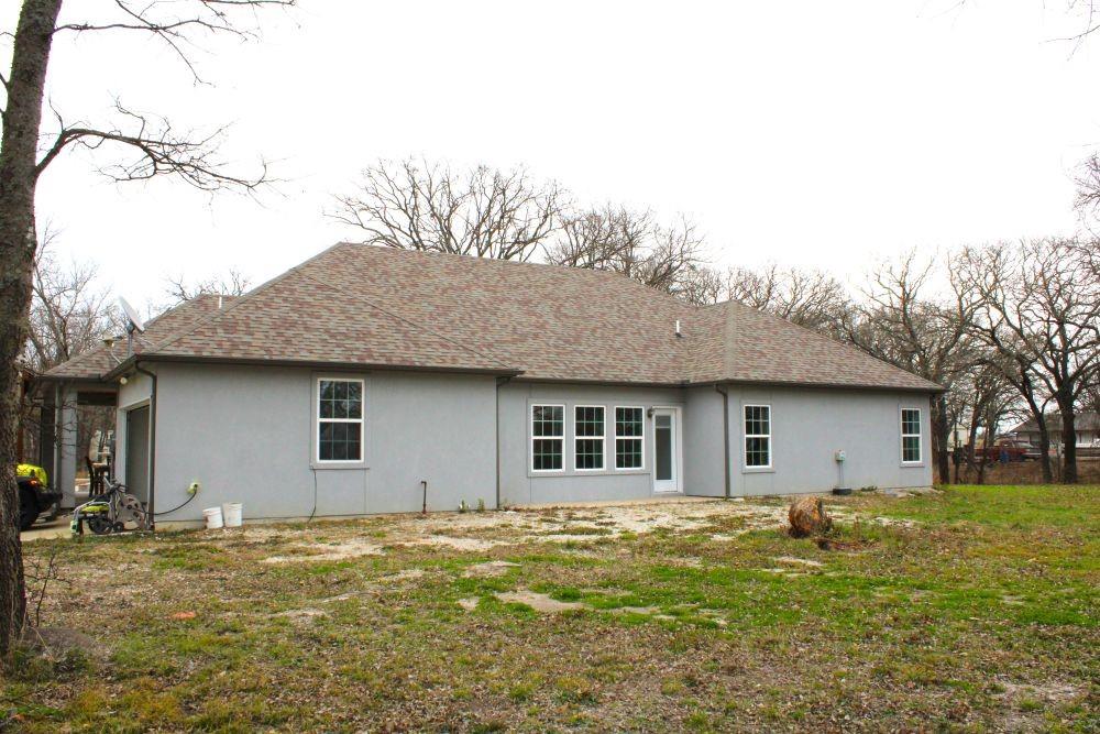 7320 County Road 3512 Quinlan, TX 75474 - Photo 6 of 35 a house view with a backyard space