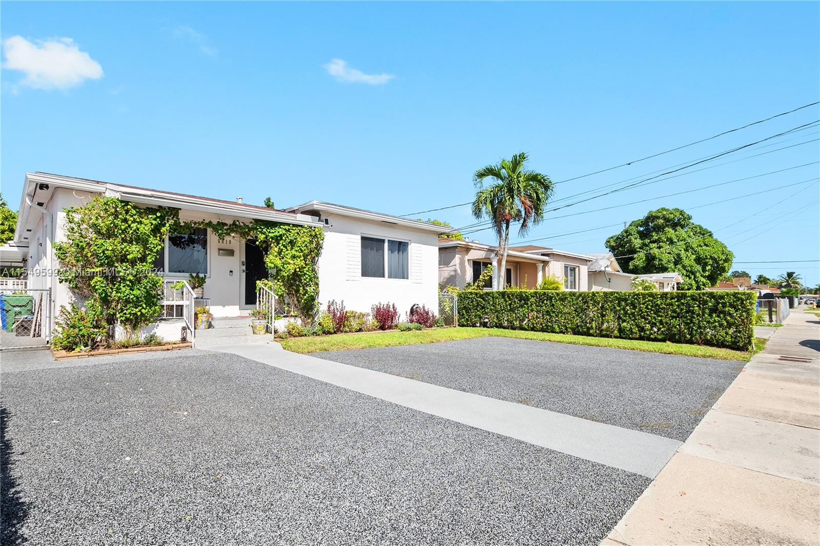 5819 Southwest 4th Street Miami, FL 33144 - Photo 2 of 27 a front view of a house with garden