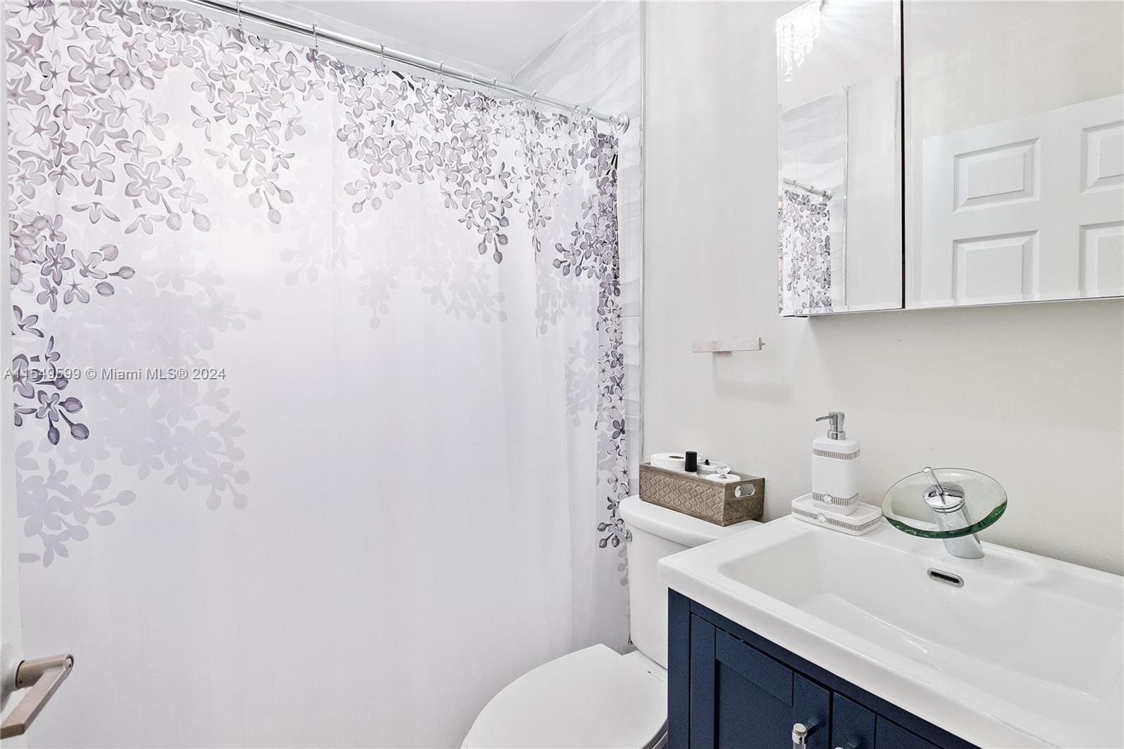 5819 Southwest 4th Street Miami, FL 33144 - Photo 22 of 27 a bathroom with a sink toilet and vanity