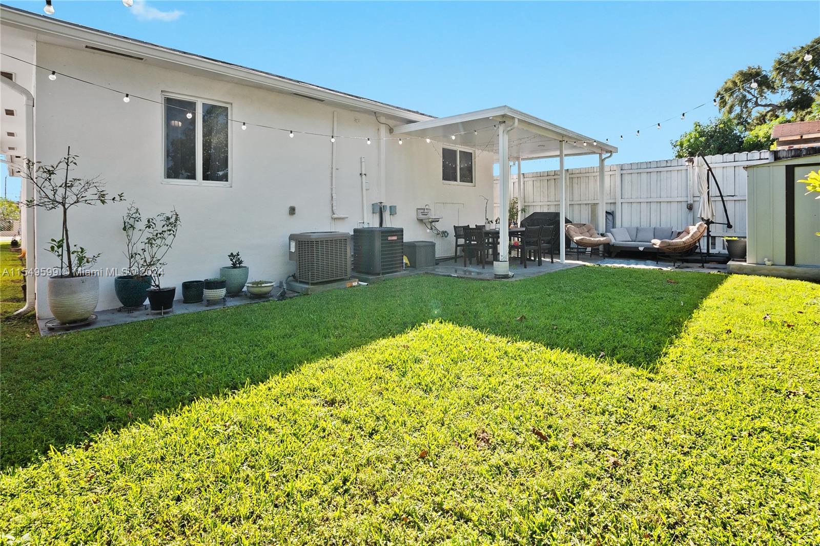 5819 Southwest 4th Street Miami, FL 33144 - Photo 26 of 27 a view of a house with backyard sitting area and garden