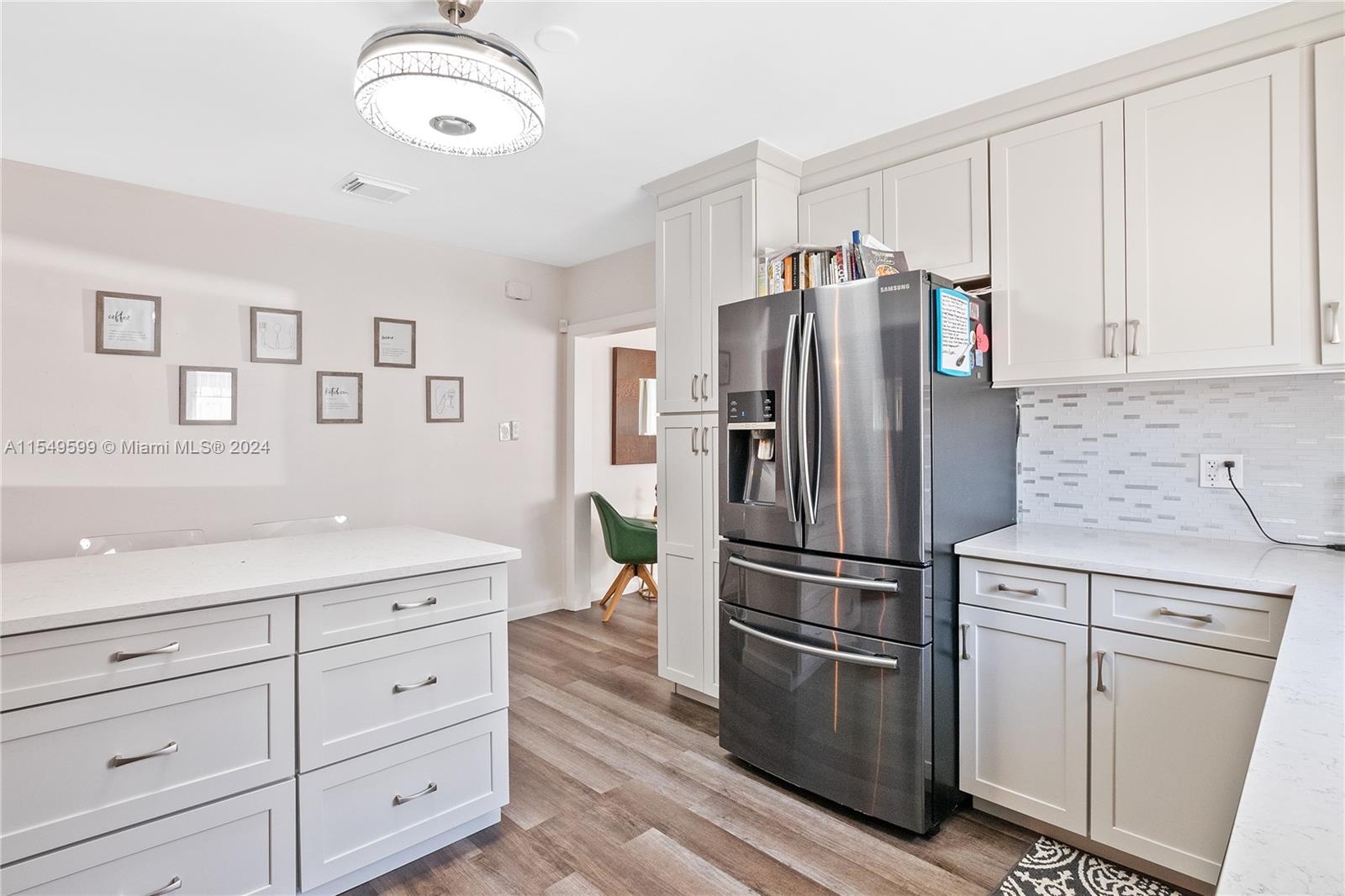 5819 Southwest 4th Street Miami, FL 33144 - Photo 8 of 27 a kitchen with cabinets stainless steel appliances and a window