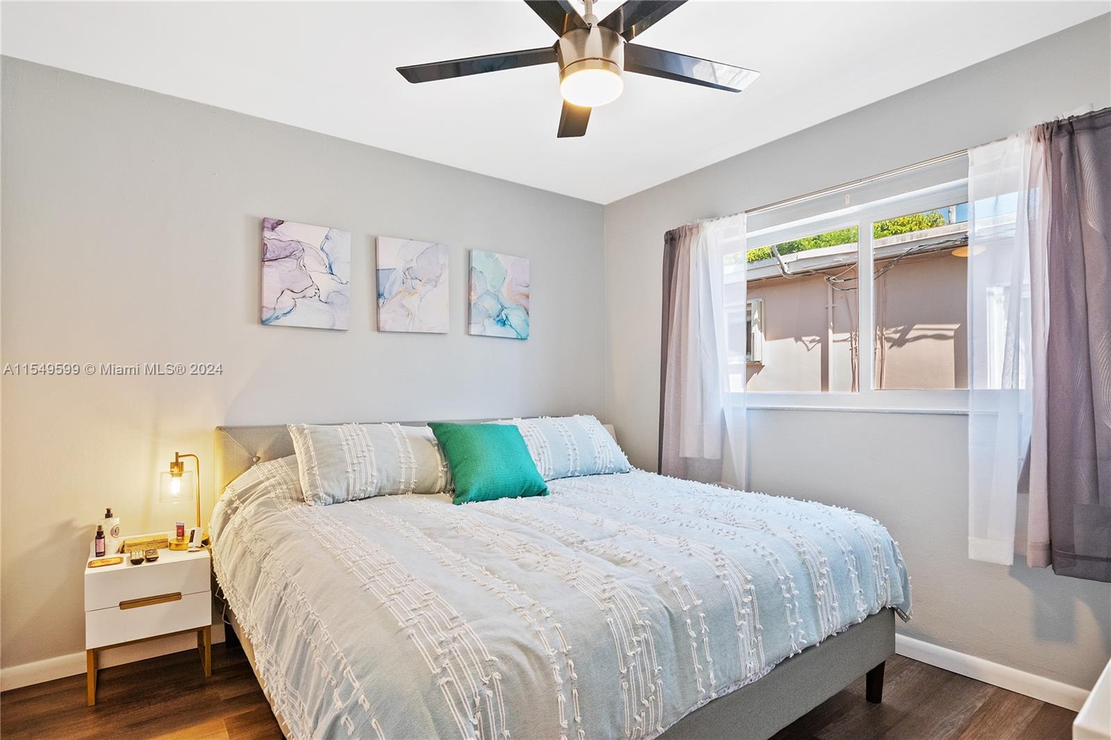 5819 Southwest 4th Street Miami, FL 33144 - Photo 10 of 27 a bedroom with a bed and painting on the wall