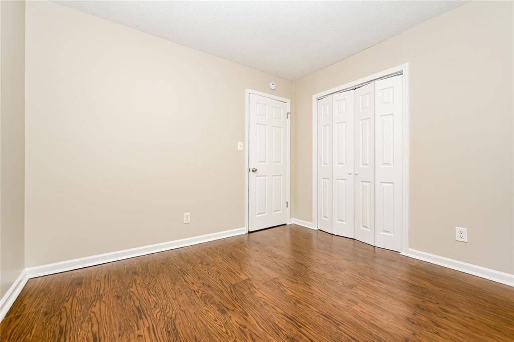 107 Parkview Drive Stockbridge, GA 30281 - Photo 11 of 25 a view of an empty room with wooden floor
