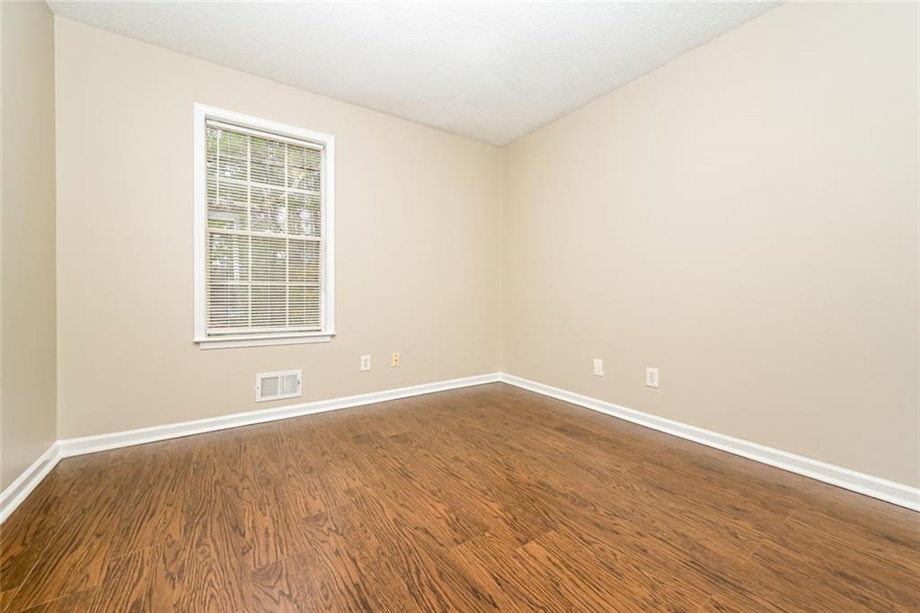 107 Parkview Drive Stockbridge, GA 30281 - Photo 12 of 25 an empty room with wooden floor and windows