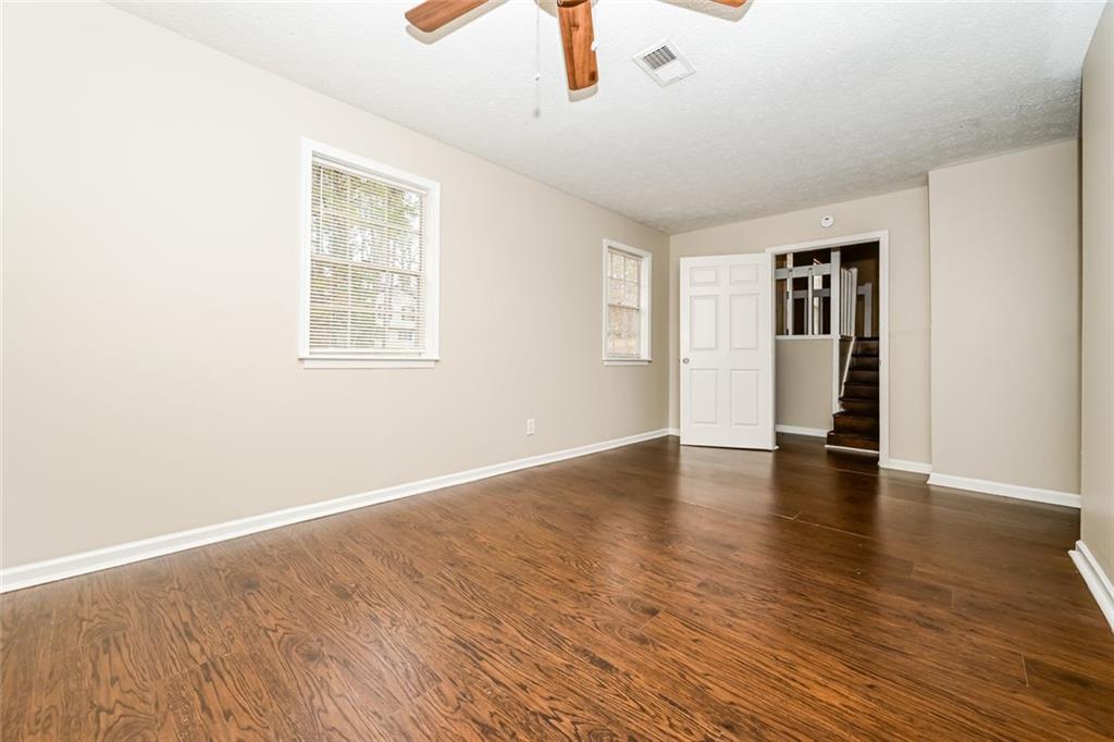 107 Parkview Drive Stockbridge, GA 30281 - Photo 13 of 25 an empty room with wooden floor and windows