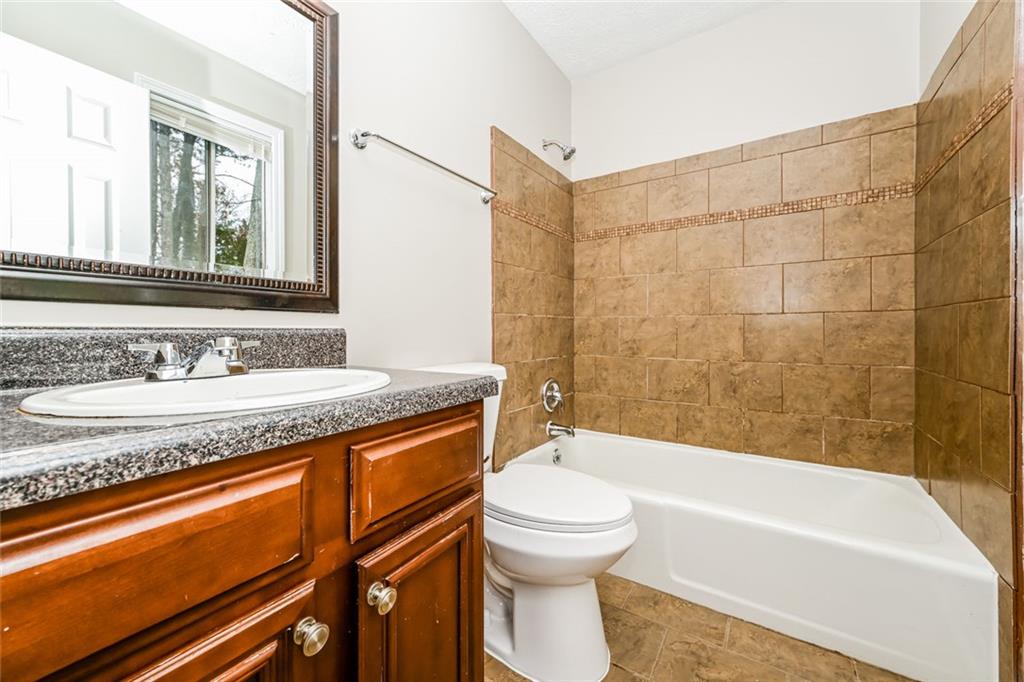 107 Parkview Drive Stockbridge, GA 30281 - Photo 17 of 25 a bathroom with a granite countertop sink a toilet and bathtub