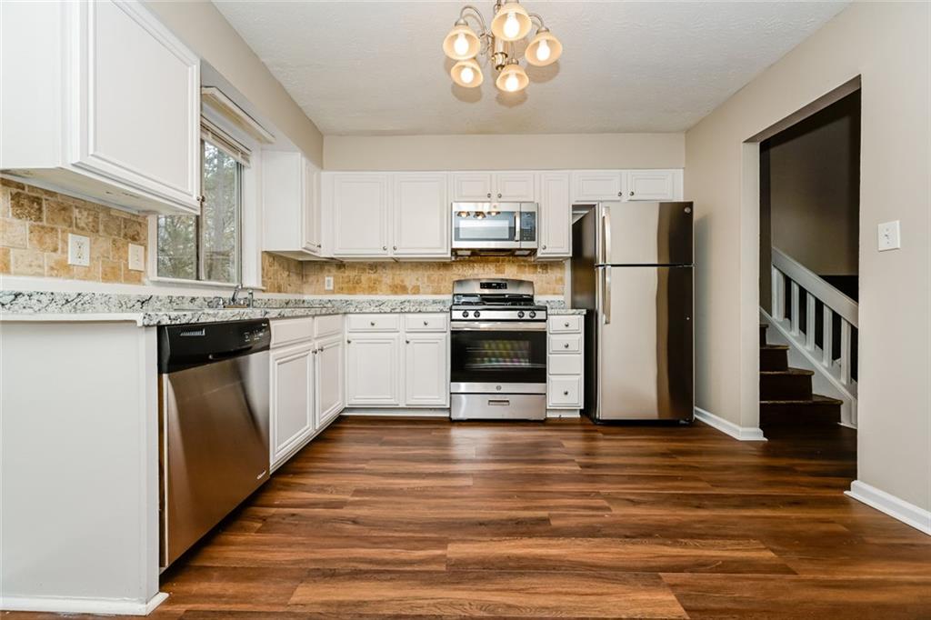 107 Parkview Drive Stockbridge, GA 30281 - Photo 21 of 25 a kitchen with stainless steel appliances a stove top oven a sink and a refrigerator