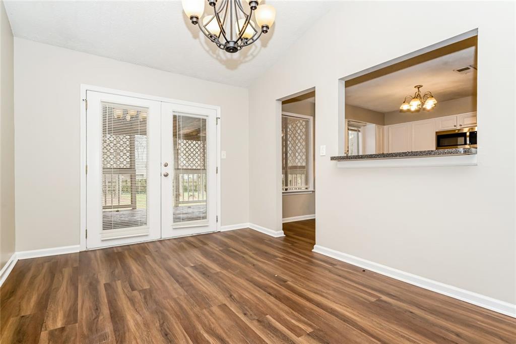 107 Parkview Drive Stockbridge, GA 30281 - Photo 22 of 25 a view of a room with wooden floor and a chandelier