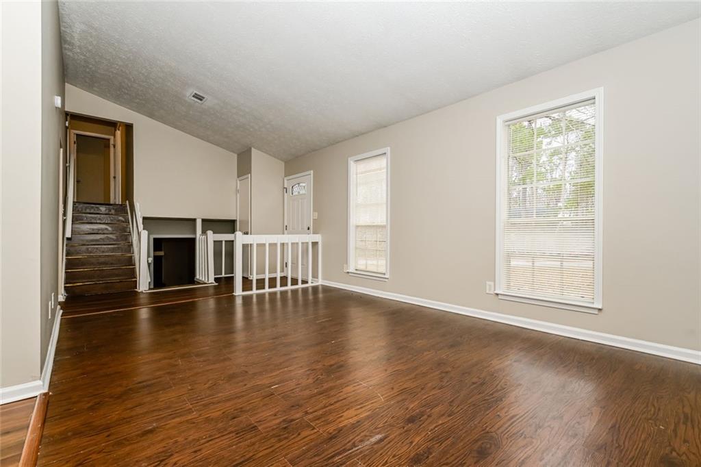 107 Parkview Drive Stockbridge, GA 30281 - Photo 24 of 25 an empty room with wooden floor and fireplace