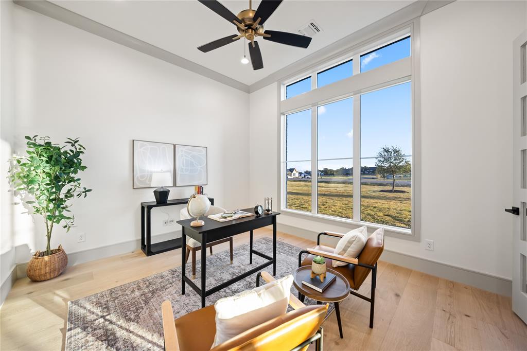 724 Cooper Trail Weatherford, TX 76087 - Photo 11 of 37 Spacious room featuring tall ceilings, light wood-finish flooring, and a contemporary ceiling fan