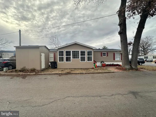 a view of a house with a backyard and a tree