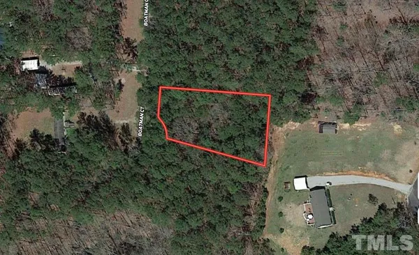 an aerial view of a house with a yard basket ball court and outdoor seating