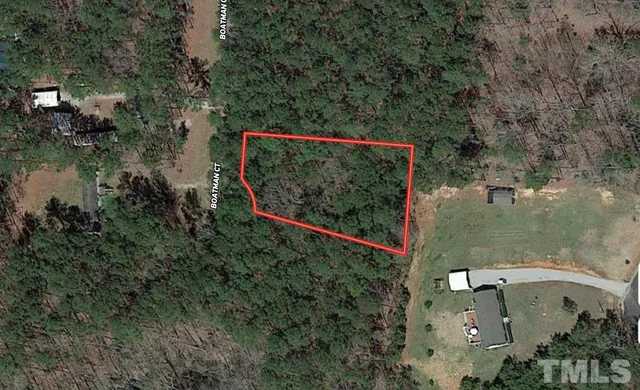 an aerial view of a house with a yard basket ball court and outdoor seating