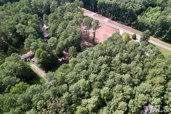 an aerial view of house with yard and outdoor space
