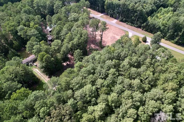 an aerial view of house with yard and outdoor space