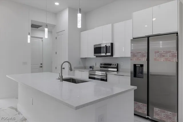 a kitchen with stainless steel appliances granite countertop a refrigerator stove and microwave