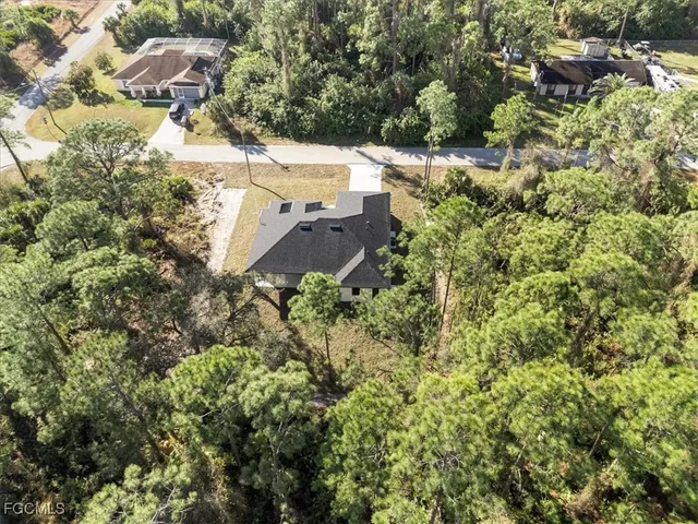 an aerial view of a house with yard