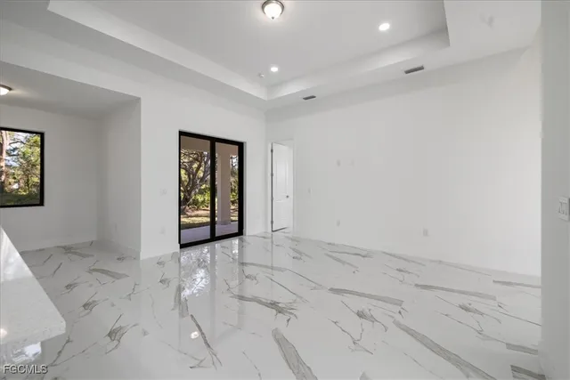 an empty room with entrance and windows