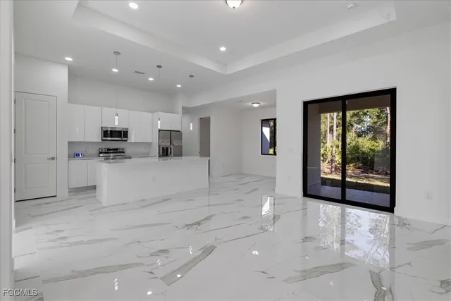 a view of kitchen with stainless steel appliances refrigerator oven and cabinets