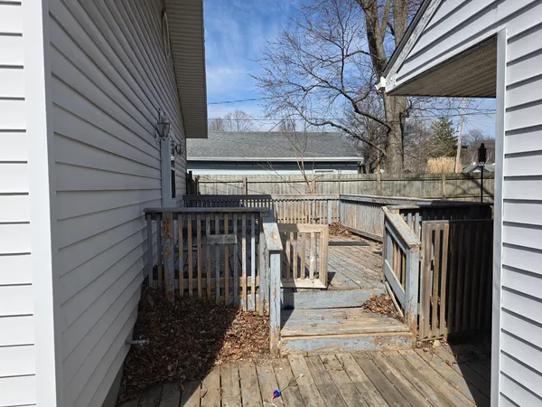 a view of entryway with wooden floor and fence