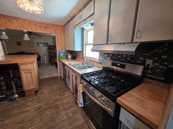 a kitchen with wooden cabinets and a stove top oven