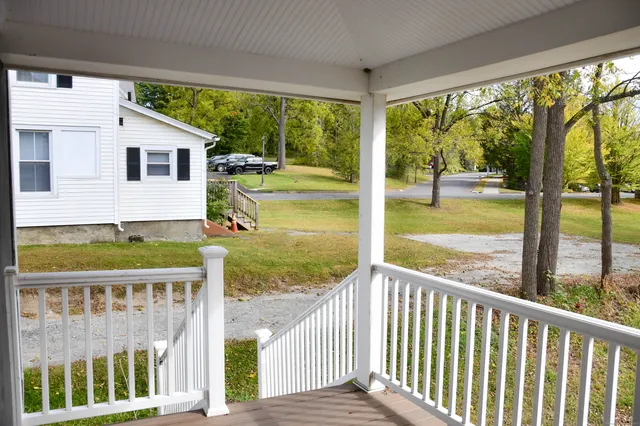 a view of a two chairs and table in the balcony