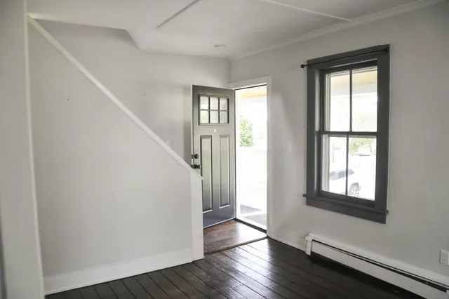 wooden floor in an empty room with a window
