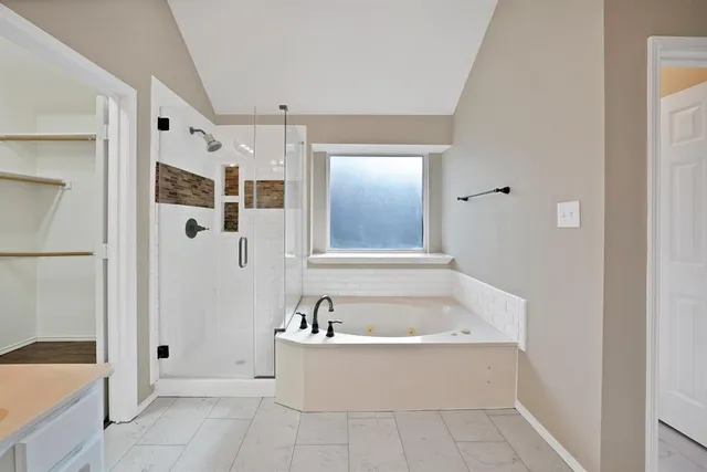 a white bath tub sitting next to a white sink