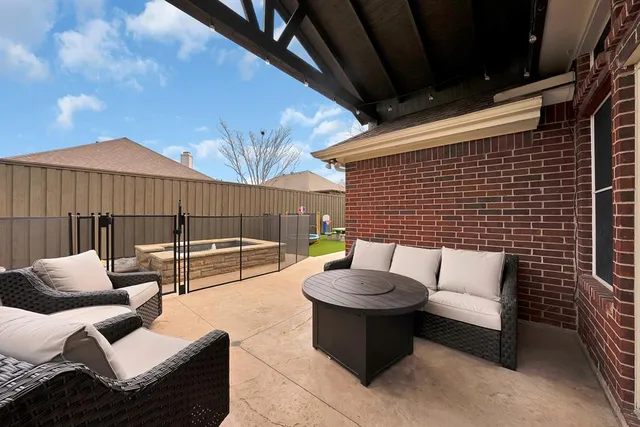 a view of a backyard with sitting area