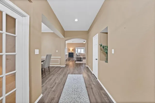 a view of a hallway with a livingroom and furniture