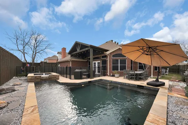 a backyard of a house with table and chairs