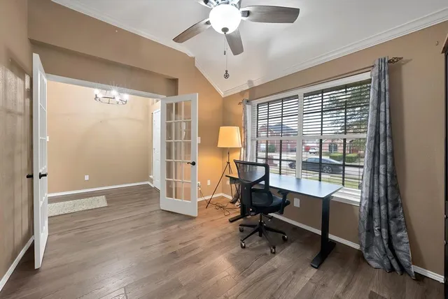 a view of a livingroom with workspace and a window
