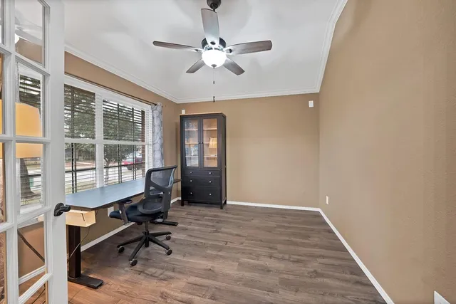 a view of a workspace with furniture and a window