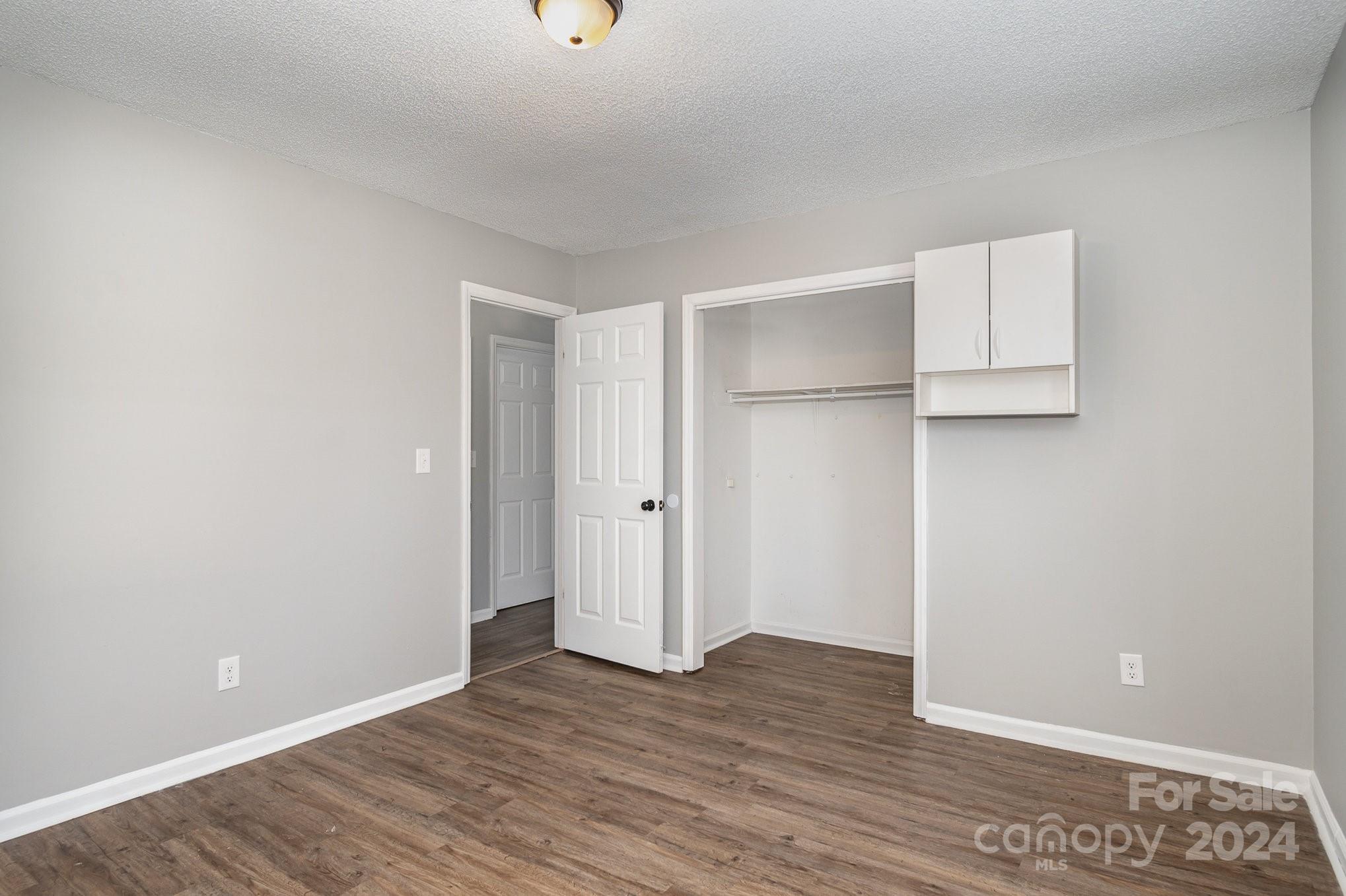 312 Moore Drive Lexington, NC 27292 - Photo 6 of 19 an empty room with wooden floor and closet