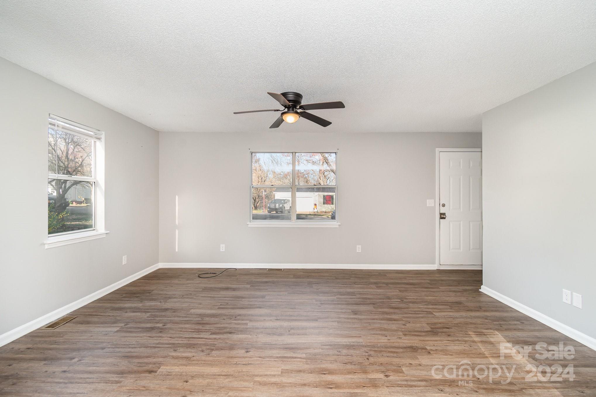 312 Moore Drive Lexington, NC 27292 - Photo 8 of 19 an empty room with wooden floor and windows
