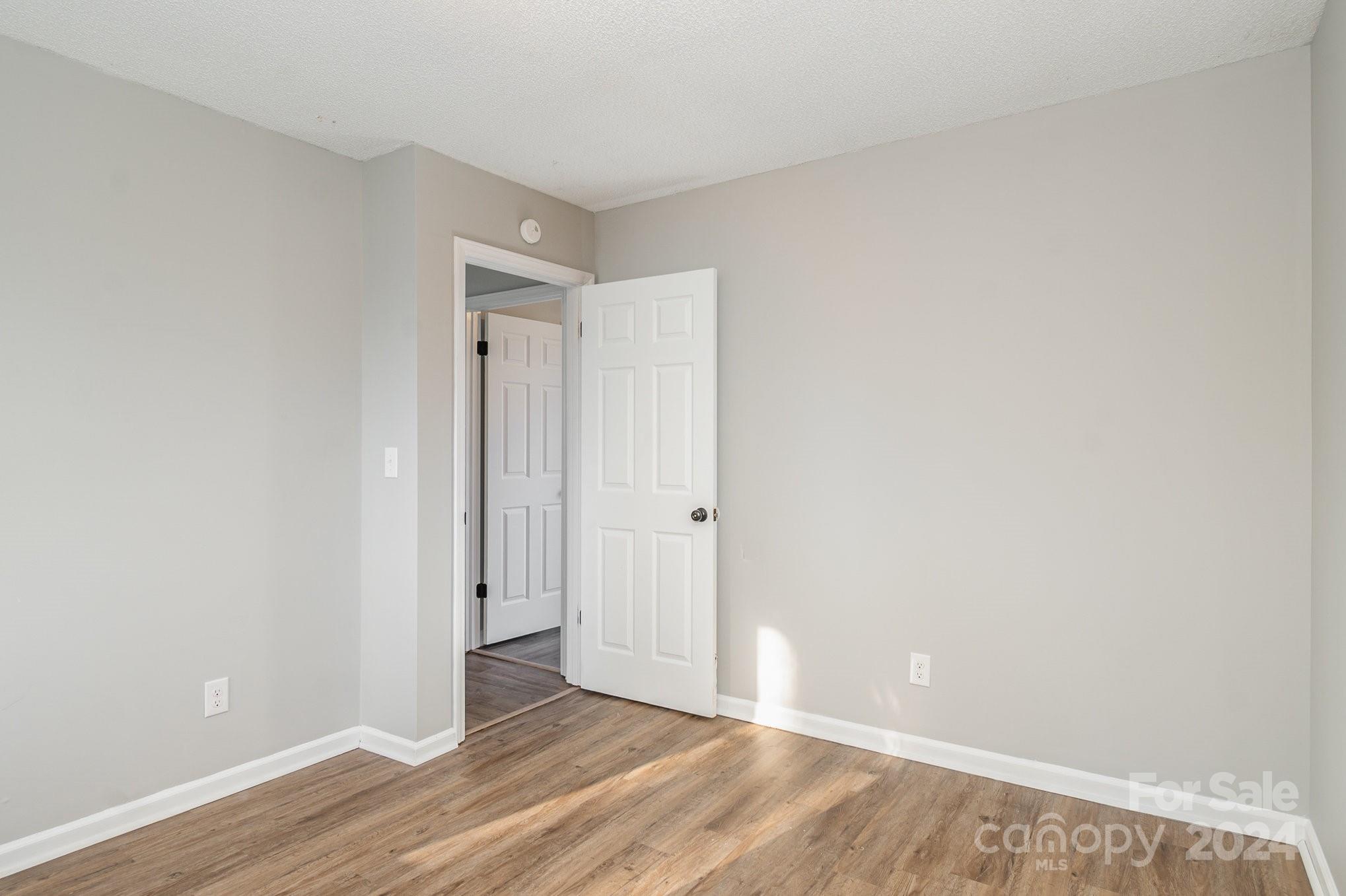 312 Moore Drive Lexington, NC 27292 - Photo 9 of 19 a view of an empty room with wooden floor