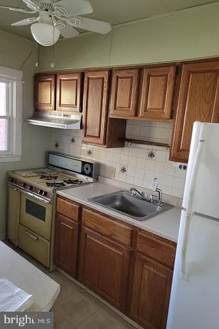a kitchen with a sink cabinets and stainless steel appliances