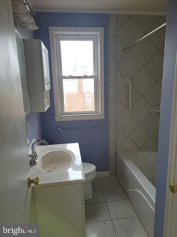 a bathroom with a sink a bath tub and a window