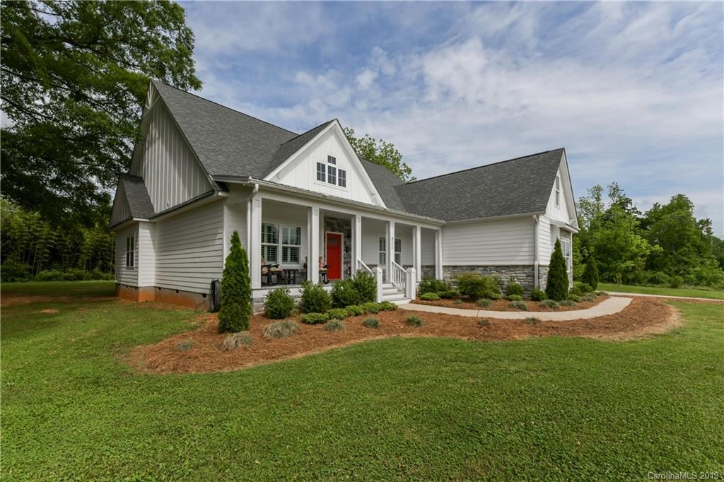 211 Scottish Highland Road Clover, SC 29710 - Photo 2 of 36 a front view of a house with a yard and garage