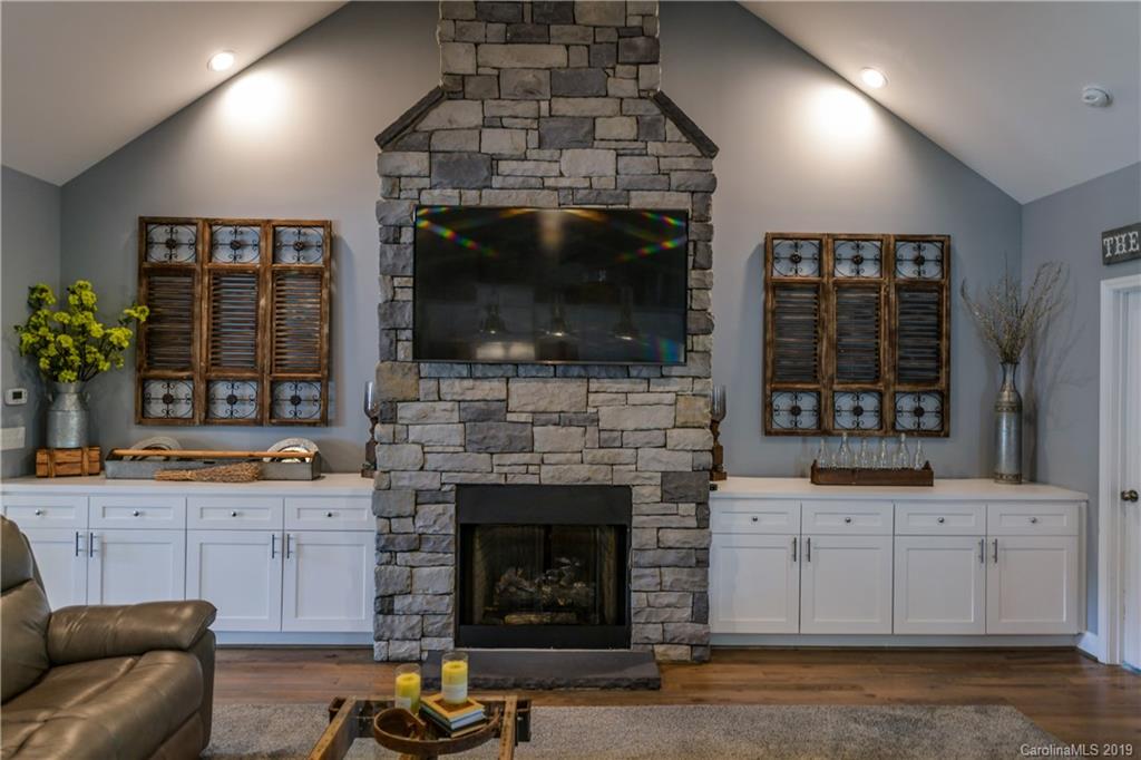 211 Scottish Highland Road Clover, SC 29710 - Photo 11 of 36 a living room with furniture a flat screen tv and a fireplace