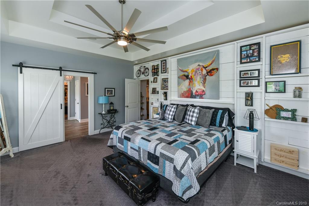 211 Scottish Highland Road Clover, SC 29710 - Photo 18 of 36 a bedroom with a bed and a chandelier
