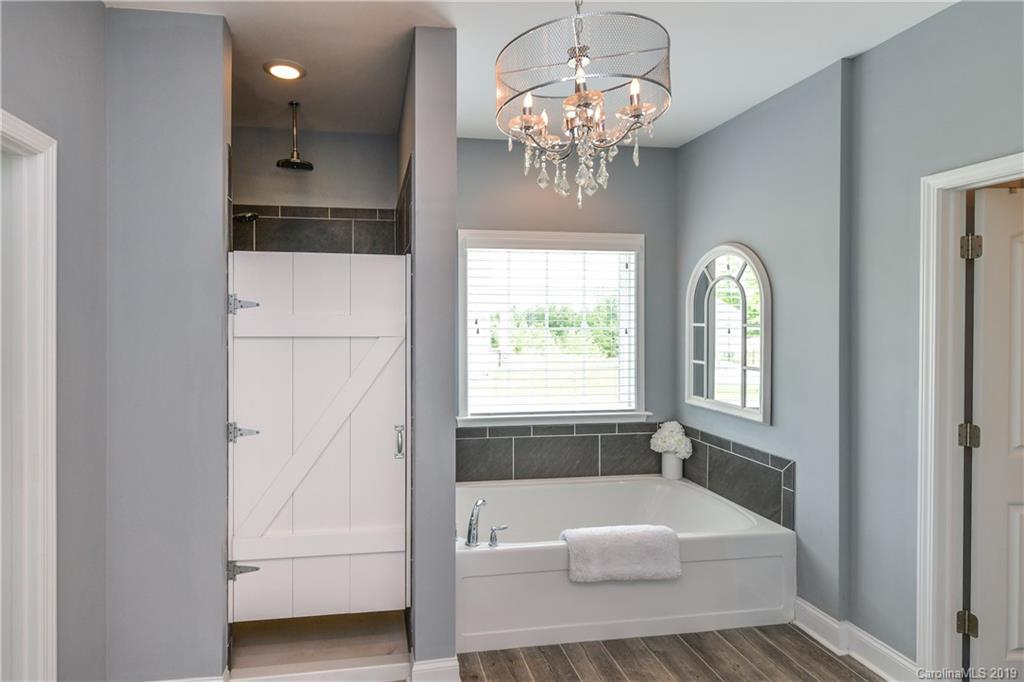 211 Scottish Highland Road Clover, SC 29710 - Photo 20 of 36 a spacious en suite bathroom with a tub shower and window