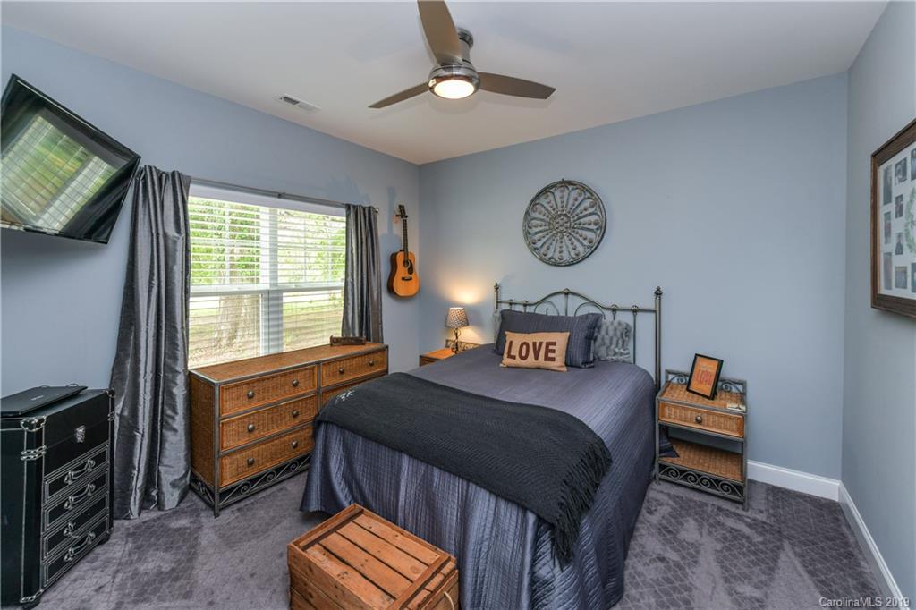 211 Scottish Highland Road Clover, SC 29710 - Photo 24 of 36 a bedroom with a bed and a chandelier
