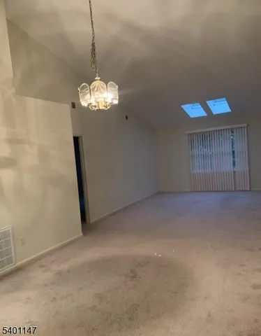 a view of a livingroom with a chandelier fan
