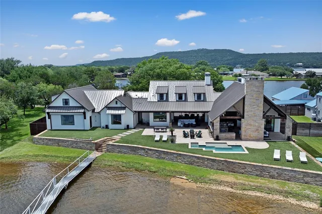 an aerial view of a house with a big yard