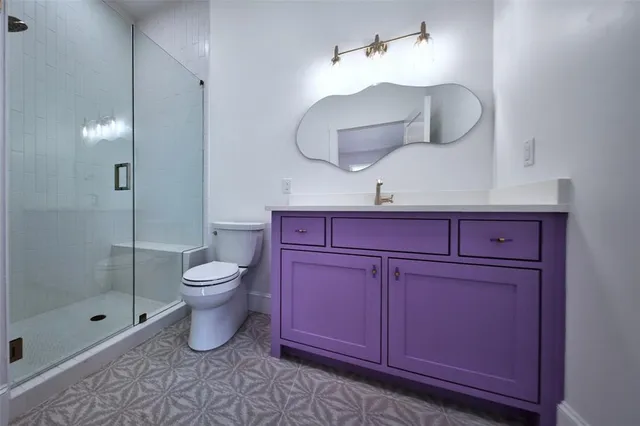 a bathroom with a toilet a sink and mirror