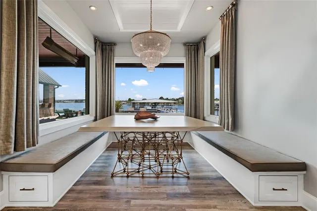 a view of a dining room with furniture wooden floor and chandelier