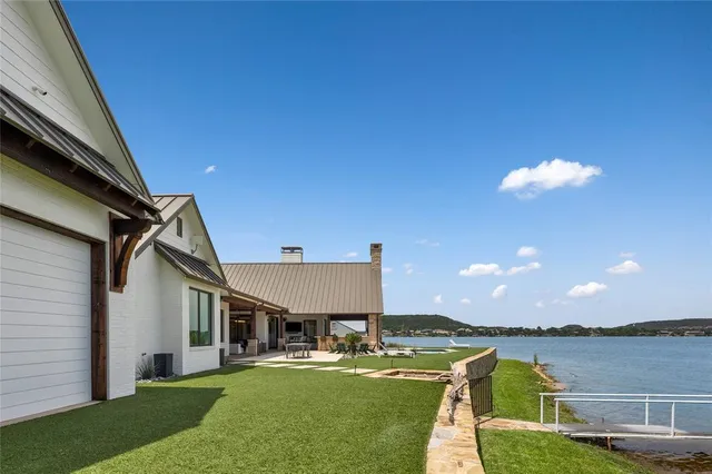 a view of a house with swimming pool and patio